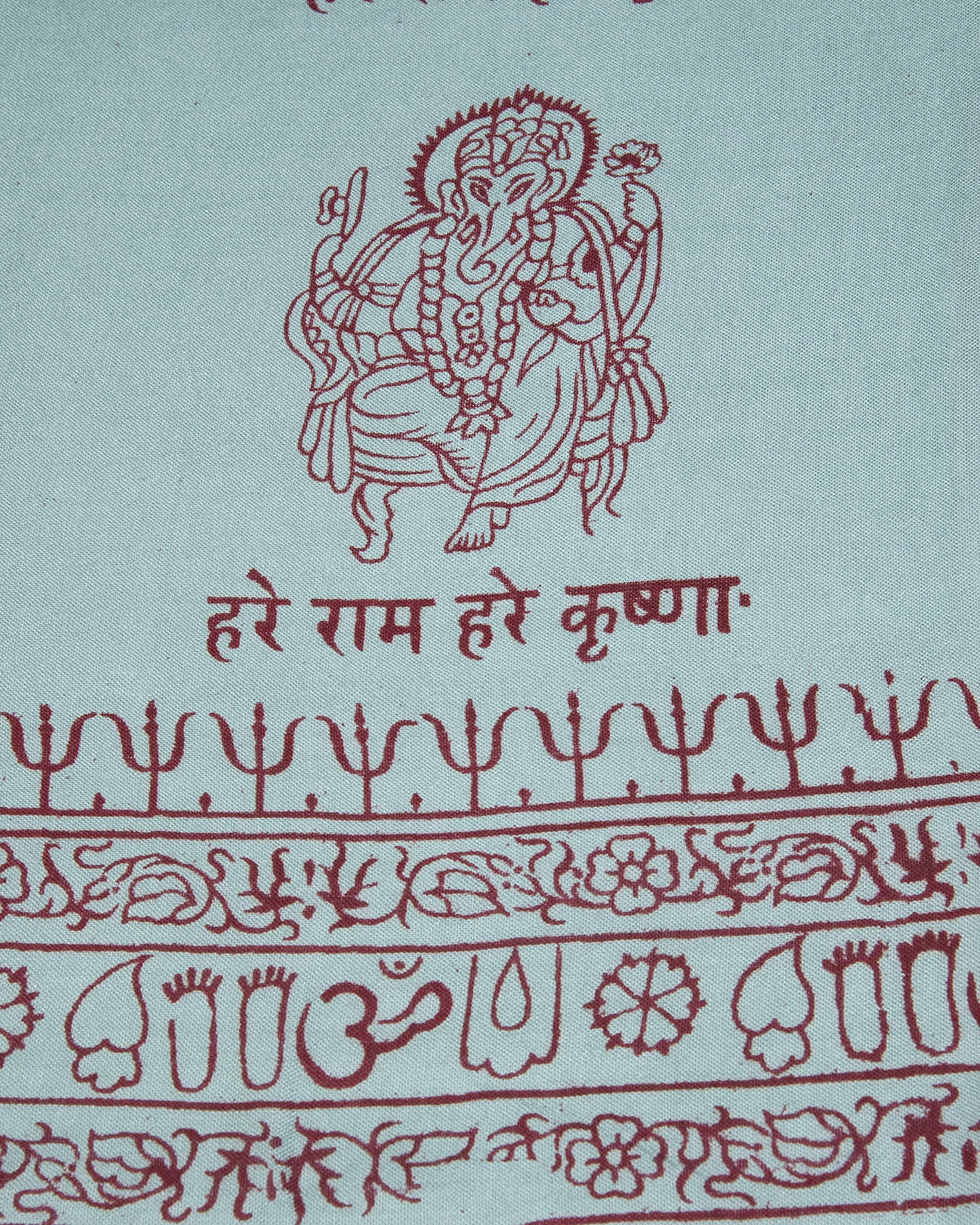 Close-up of turquoise Ganesha motif on Indian yoga scarf, ethical handmade spiritual accessory.