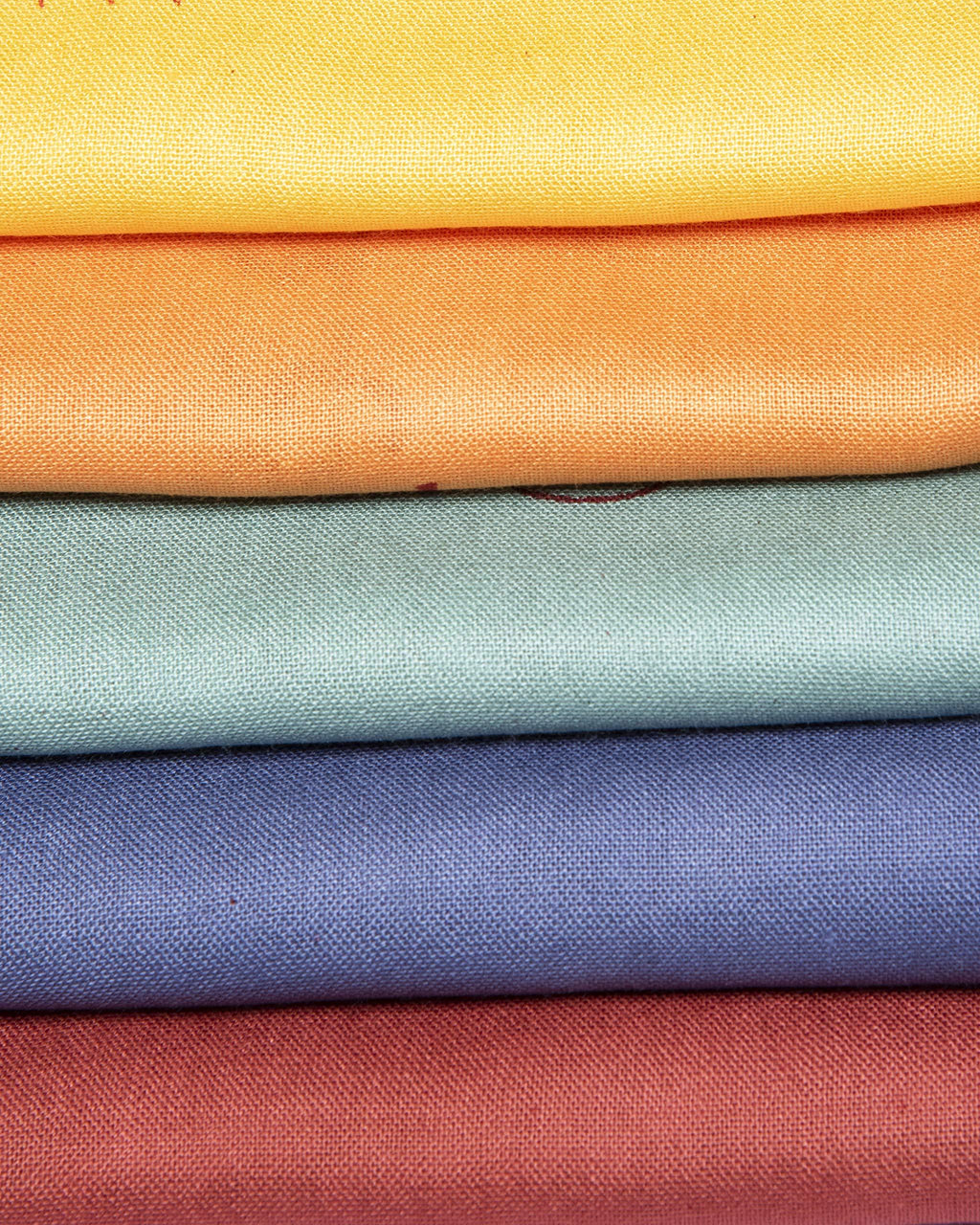 Yoga shawls in a variety of colors hand-dyed and screen printed by hand in Vasarani